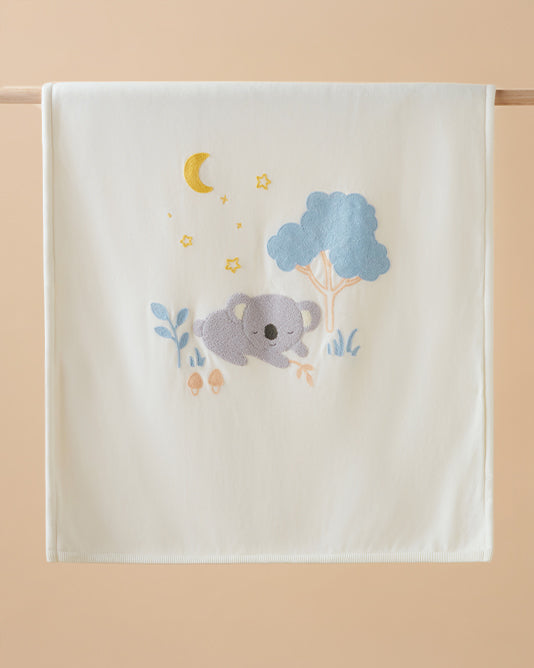 baby blanket hanging on wooden rod