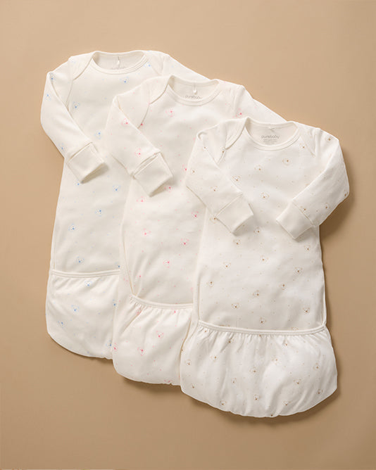 3 white baby sleepsuits